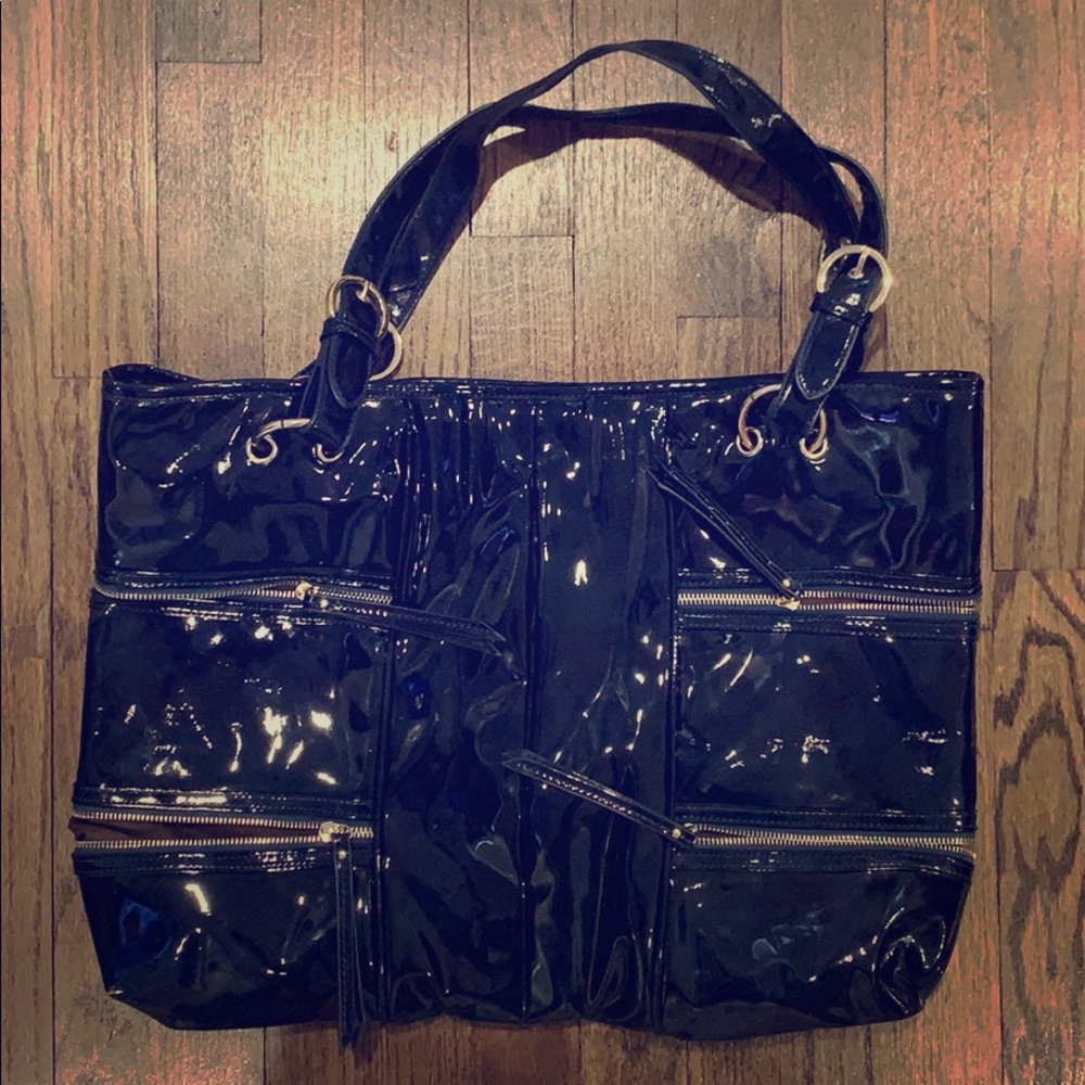 Shiny navy blue bag with many zippers